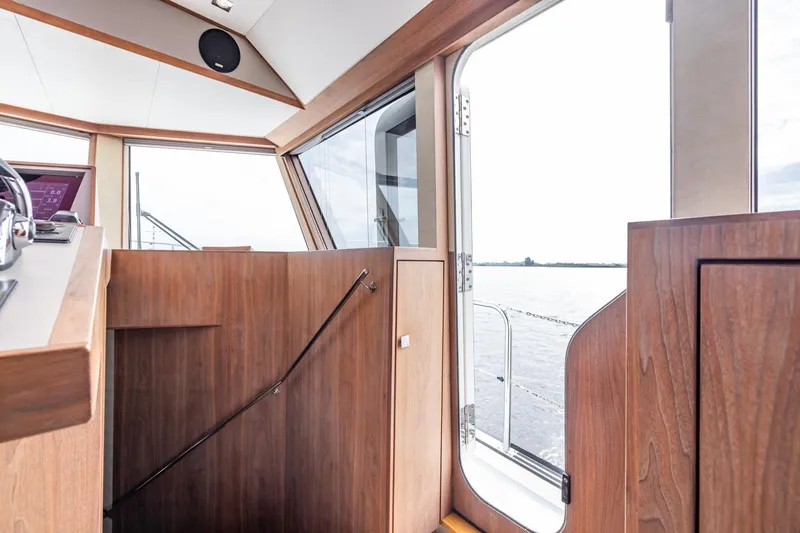 Wild Thing Yacht Photos Pics Interior view of 2016 Explorer NG 50 Alu Fast Going yacht with wooden finish and open door.