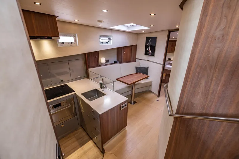 Wild Thing Yacht Photos Pics Luxurious interior of 2016 Explorer NG 50 Alu Fast Going yacht, featuring modern kitchen and dining area.