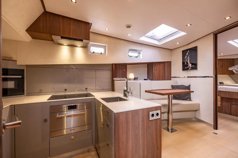 Wild Thing Yacht Photos Pics Luxurious 2016 Explorer NG 50 yacht interior with modern kitchen and cozy dining area.