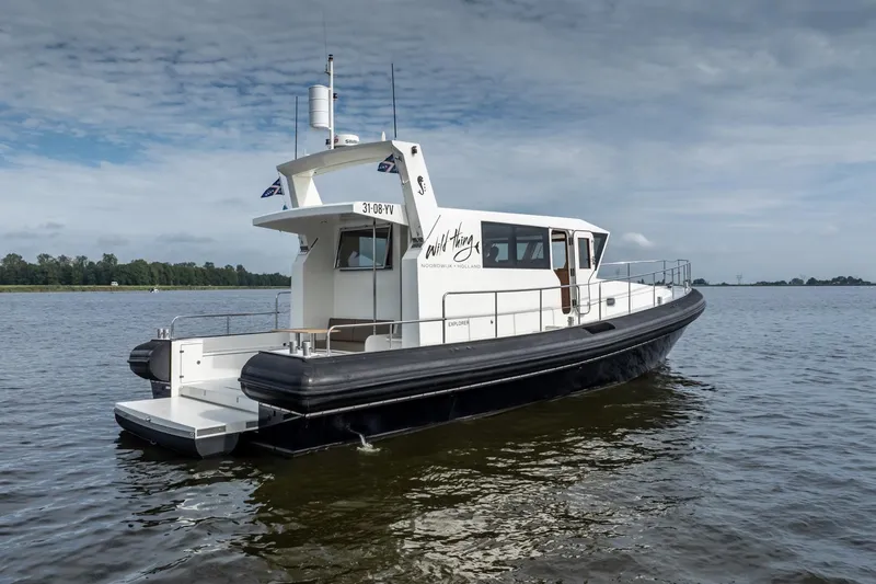 Wild Thing Yacht Photos Pics 2016 Explorer NG 50 Alu Fast Going boat on calm water under cloudy sky.