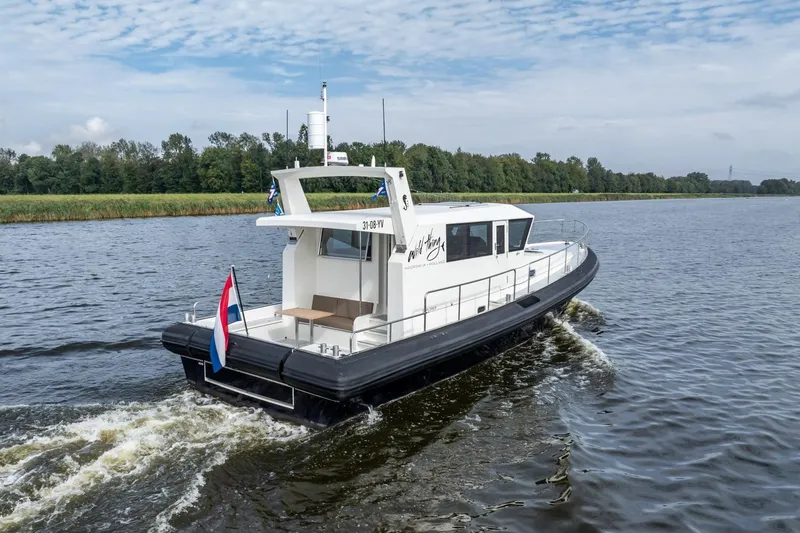 Wild Thing Yacht Photos Pics 2016 Explorer NG 50 Alu Fast Going boat cruising on a river with scenic background.