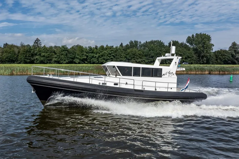 Wild Thing Yacht Photos Pics 2016 Explorer NG 50 Alu Fast Going boat cruising on a river.