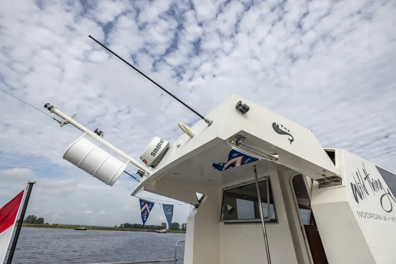 Wild Thing Yacht Photos Pics 2016 Explorer NG 50 Alu Fast Going boat with radar, flags, and cloudy sky.