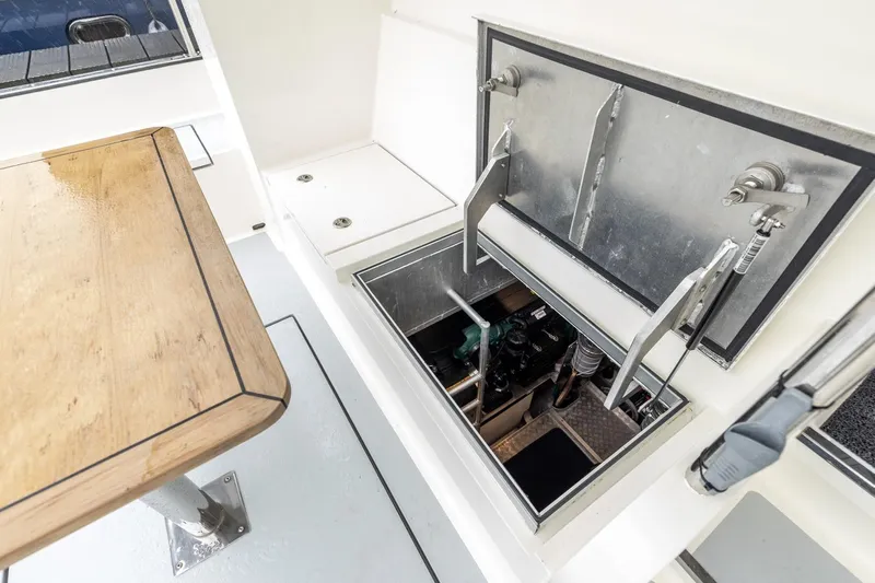 Wild Thing Yacht Photos Pics 2016 Explorer NG 50 Alu Fast Going yacht engine compartment with open hatch and wooden table.