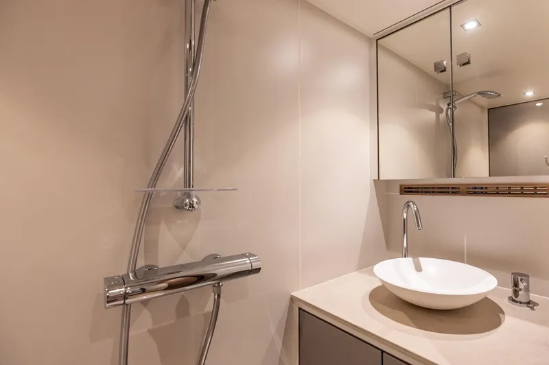 Wild Thing Yacht Photos Pics Modern yacht bathroom with sleek fixtures, vessel sink, and mirrored cabinet, 2016 Explorer NG 50 Alu.