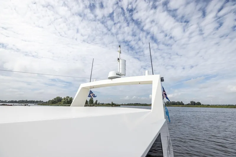 Wild Thing Yacht Photos Pics Explorer NG 50 Alu Fast Going 2016 boat on a serene lake under a cloudy sky.