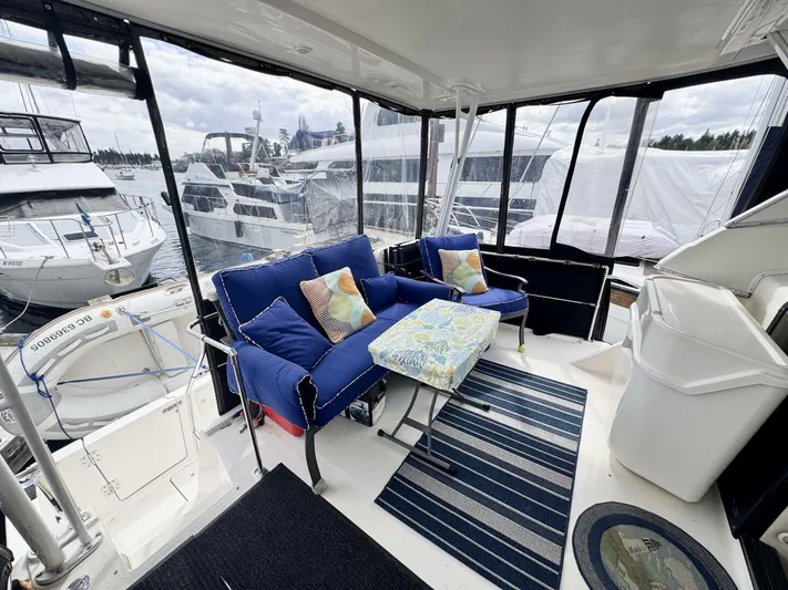  Yacht Photos Pics 1998 Bayliner 4087 Aft Cabin Motoryacht interior with blue seating and marina view.