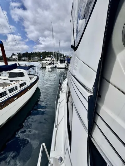  Yacht Photos Pics 1998 Bayliner 4087 Aft Cabin Motoryacht docked in a marina, surrounded by other boats.