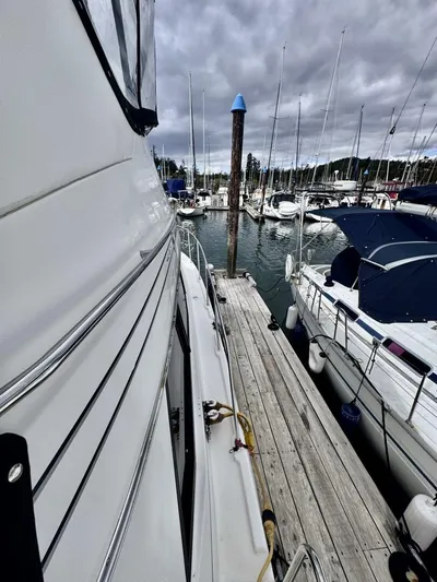  Yacht Photos Pics 1998 Bayliner 4087 Aft Cabin Motoryacht docked at marina, surrounded by sailboats.