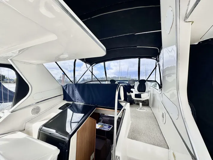  Yacht Photos Pics 1998 Bayliner 4087 Aft Cabin Motoryacht interior with seating and helm, featuring sleek design elements.