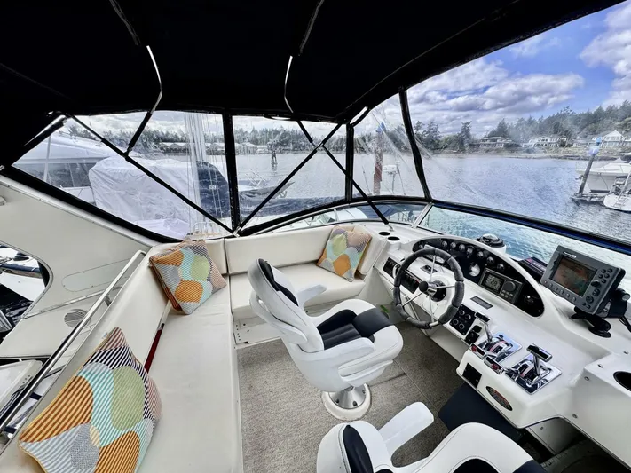  Yacht Photos Pics 1998 Bayliner 4087 Aft Cabin Motoryacht cockpit with modern controls and scenic marina view.