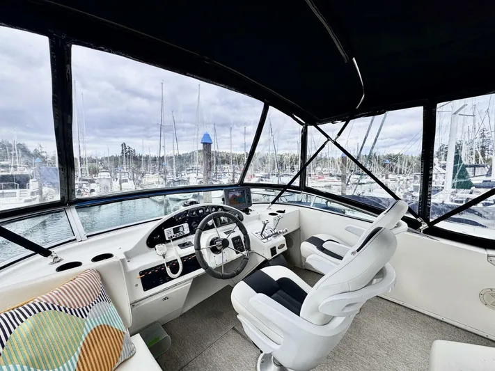  Yacht Photos Pics 1998 Bayliner 4087 Aft Cabin Motoryacht helm with marina view, featuring modern controls and seating.