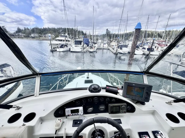  Yacht Photos Pics 1998 Bayliner 4087 Aft Cabin Motoryacht helm view in marina, surrounded by sailboats.