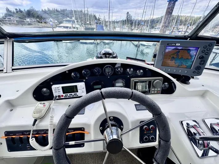  Yacht Photos Pics 1998 Bayliner 4087 Aft Cabin Motoryacht helm with navigation equipment and marina view.