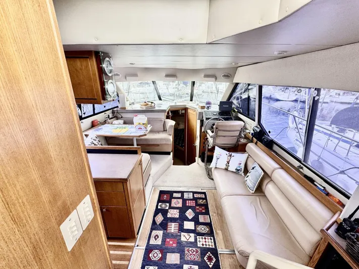  Yacht Photos Pics 1998 Bayliner 4087 Aft Cabin Motoryacht interior with seating, table, and helm station.