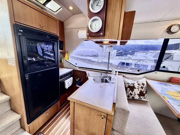  Yacht Photos Pics 1998 Bayliner 4087 Aft Cabin Motoryacht interior with kitchen, seating, and large windows.