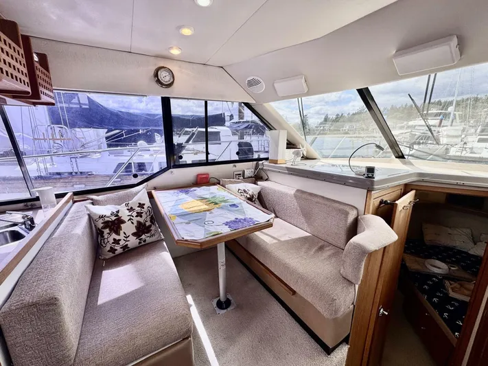  Yacht Photos Pics 1998 Bayliner 4087 Aft Cabin Motoryacht interior with dining area and scenic window views.