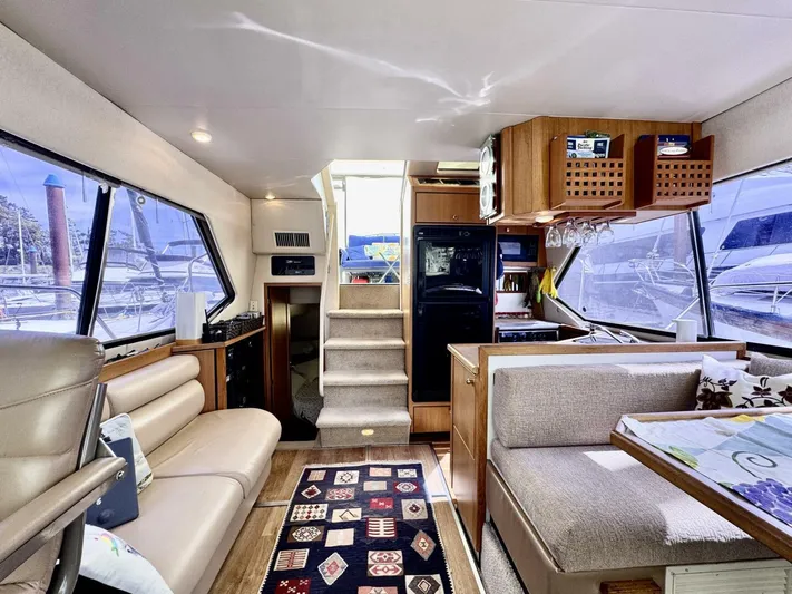  Yacht Photos Pics 1998 Bayliner 4087 Aft Cabin Motoryacht interior with seating, kitchen, and stairs.