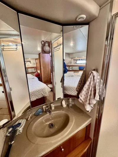  Yacht Photos Pics 1998 Bayliner 4087 Aft Cabin Motoryacht bathroom with sink, mirror, and towel.
