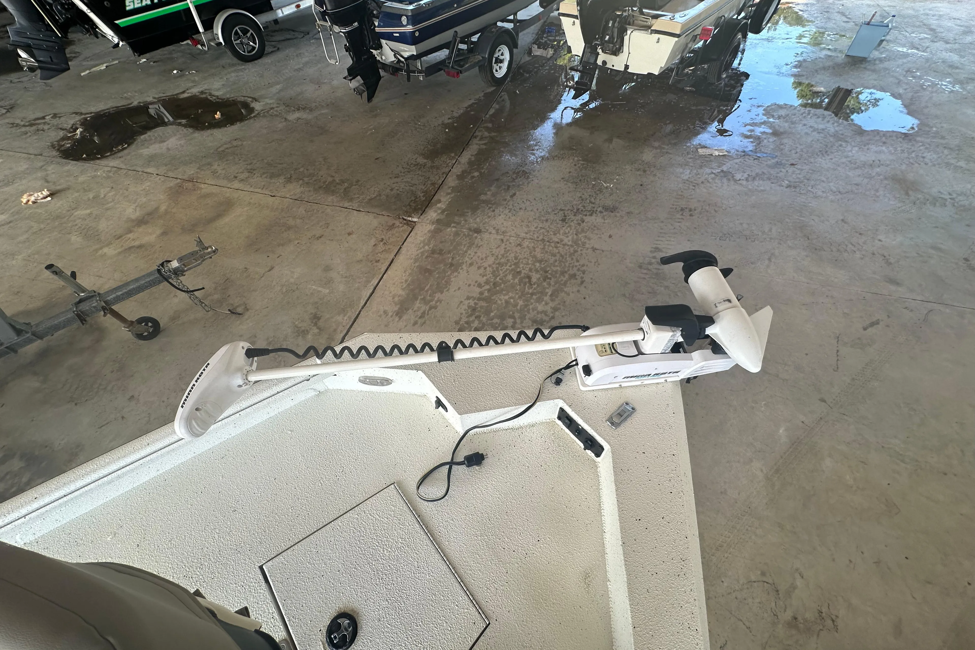 2018 Excel 220 Bay Pro boat with trolling motor in a garage setting.