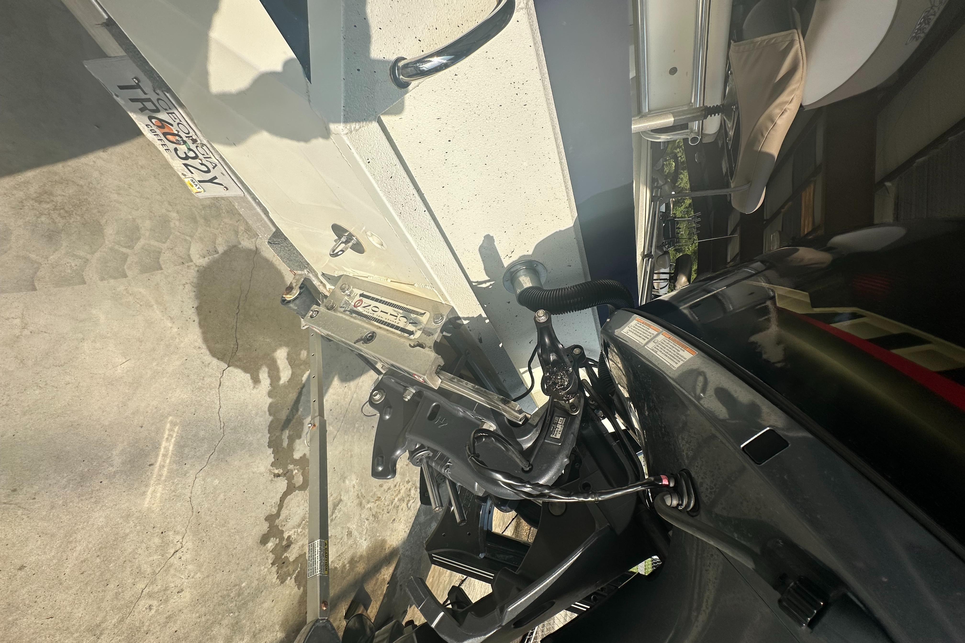 Close-up of 2018 Excel 220 Bay Pro boat motor and trailer components.