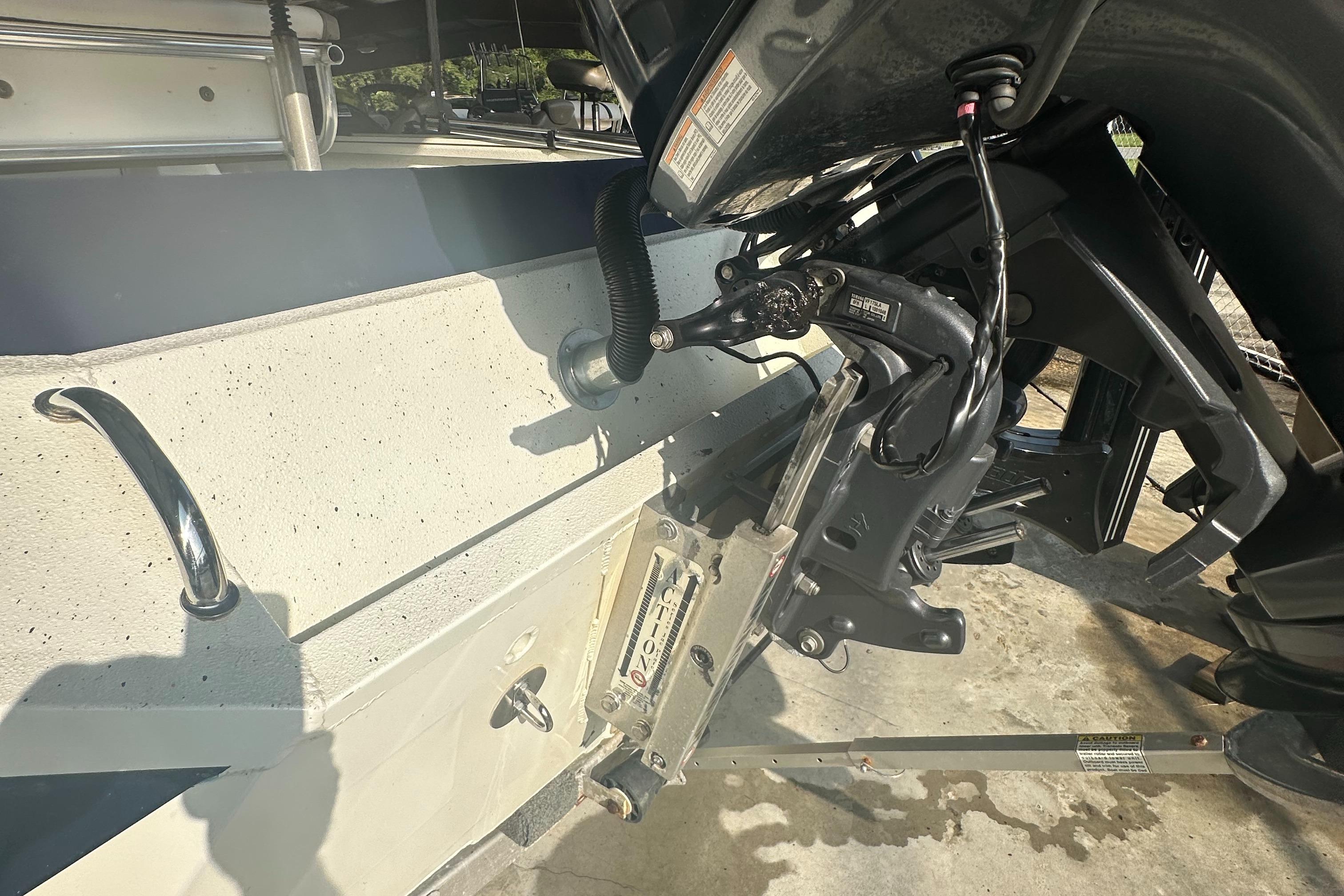 2018 Excel 220 Bay Pro boat motor and transom detail in sunlight.