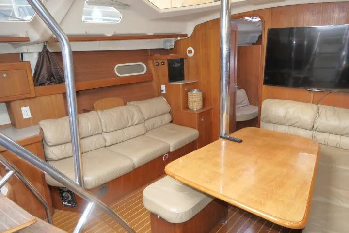Interior of 1999 Hunter 450 Passage yacht with wood finish and beige seating.