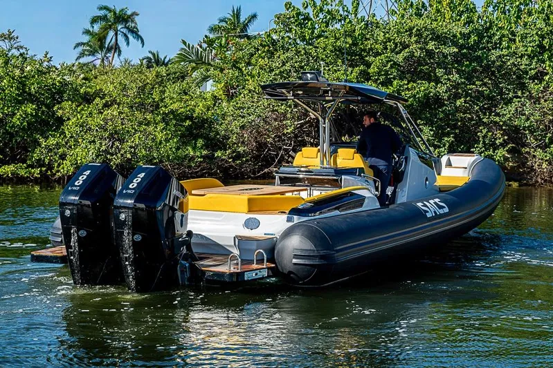  Yacht Photos Pics 2025 SACS Strider 11 boat with dual engines cruising on a scenic waterway.
