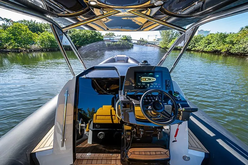  Yacht Photos Pics 2025 SACS Strider 11 luxury yacht cockpit with advanced navigation system on a scenic waterway.