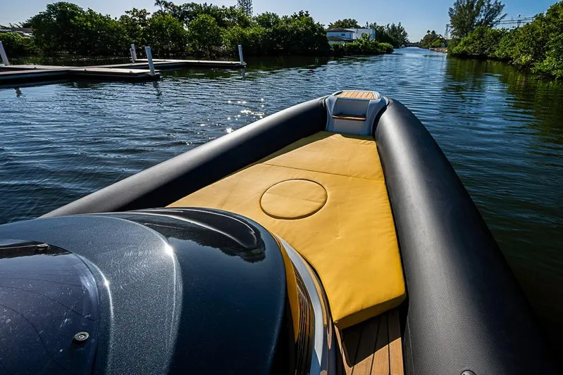  Yacht Photos Pics 2025 SACS Strider 11 luxury boat with yellow seating, cruising on a serene waterway.