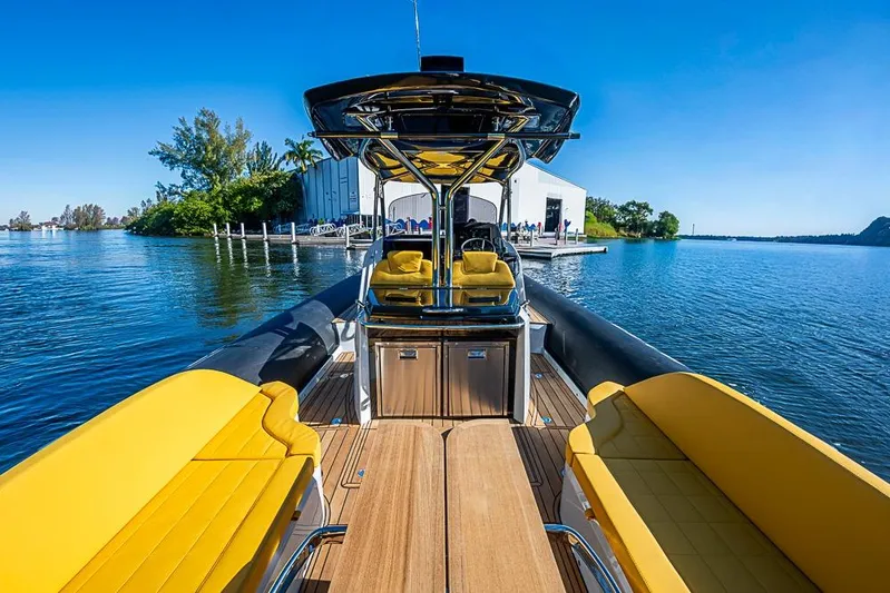  Yacht Photos Pics 2025 SACS Strider 11 boat with yellow seating, docked on a sunny day.