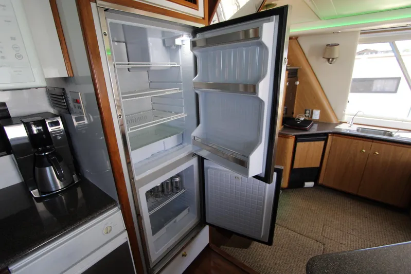  Yacht Photos Pics Open refrigerator in 2000 Bayliner 4788 Pilothouse Motoryacht kitchen interior.
