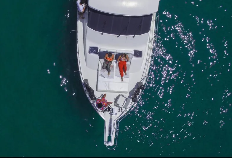  Yacht Photos Pics Aerial view of 2000 Bayliner 4788 Pilothouse Motoryacht on clear blue water.