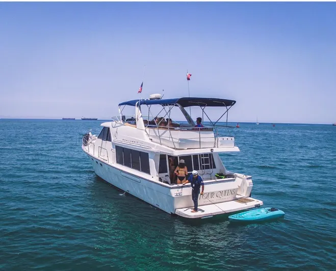  Yacht Photos Pics 2000 Bayliner 4788 Pilothouse Motoryacht on open water, with people enjoying the deck.