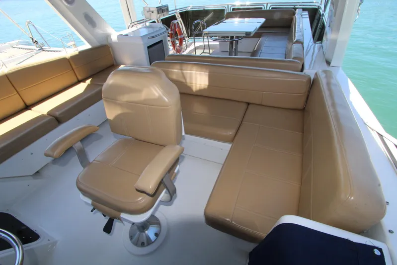  Yacht Photos Pics 2000 Bayliner 4788 Pilothouse Motoryacht interior with tan seating and ocean view.