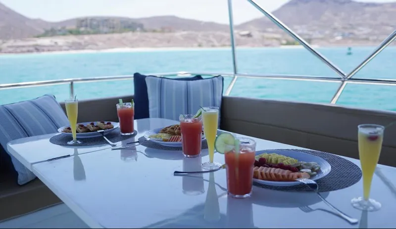  Yacht Photos Pics Outdoor dining setup on 2000 Bayliner 4788 yacht with ocean view and fresh juices.