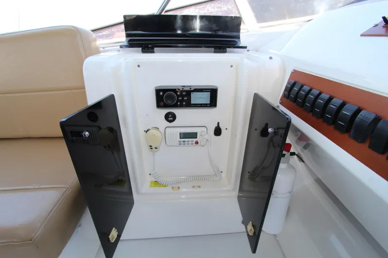  Yacht Photos Pics Control panel of a 2000 Bayliner 4788 Pilothouse Motoryacht with open cabinet doors.