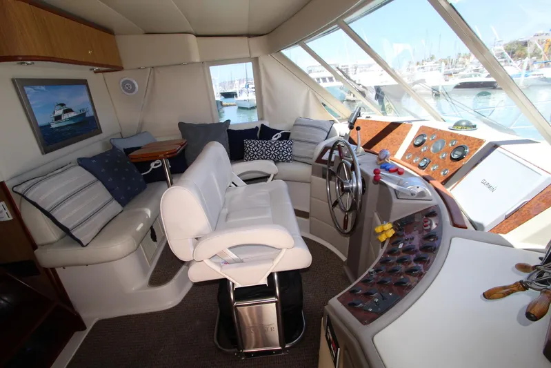  Yacht Photos Pics 2000 Bayliner 4788 Pilothouse Motoryacht interior with helm, seating, and marina view.