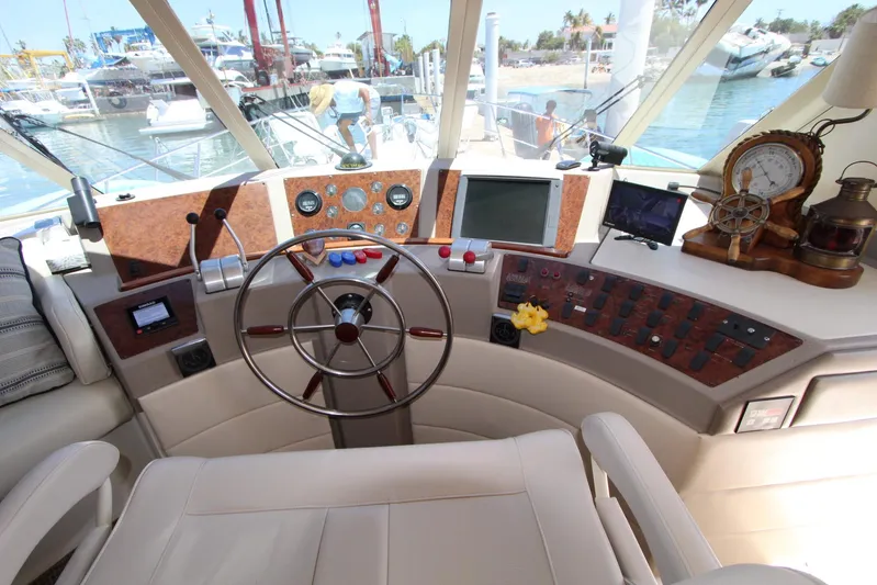  Yacht Photos Pics Pilothouse interior of 2000 Bayliner 4788 Motoryacht with steering wheel and navigation equipment.