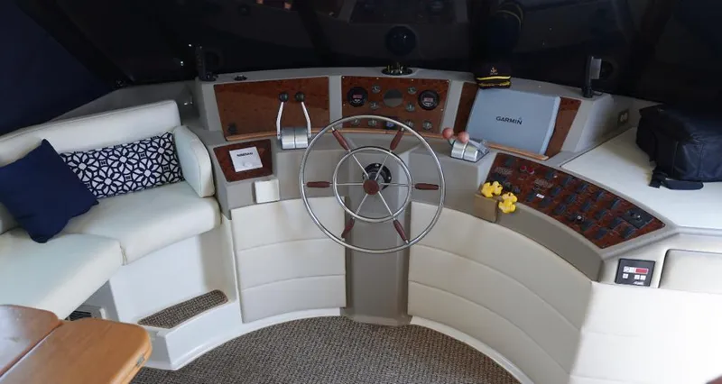  Yacht Photos Pics Pilothouse interior of 2000 Bayliner 4788 Motoryacht with steering wheel and seating area.