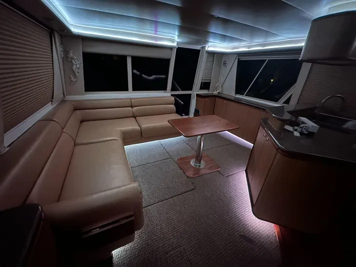  Yacht Photos Pics Luxurious interior of 2000 Bayliner 4788 Pilothouse Motoryacht with ambient lighting and plush seating.