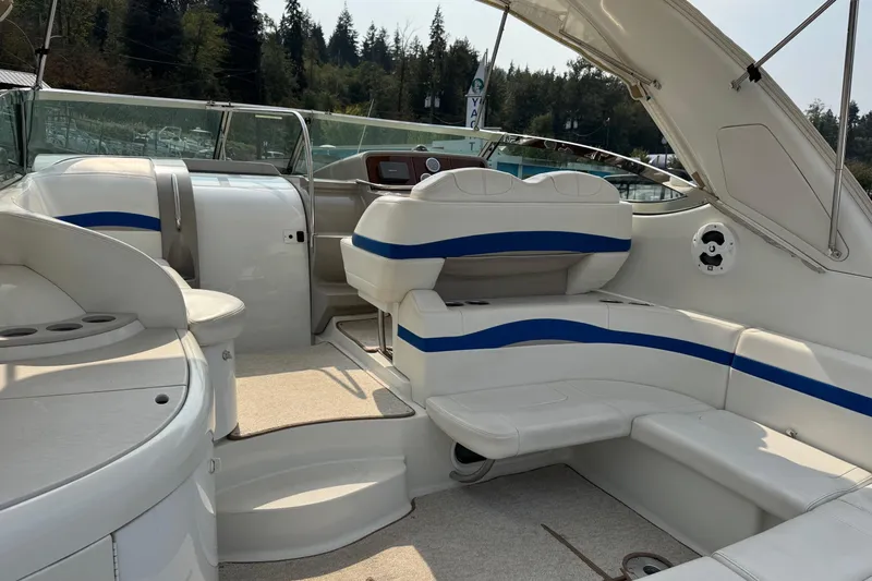  Yacht Photos Pics 2003 Formula 37 Performance Cruiser interior with white and blue seating, docked near forested shoreline.