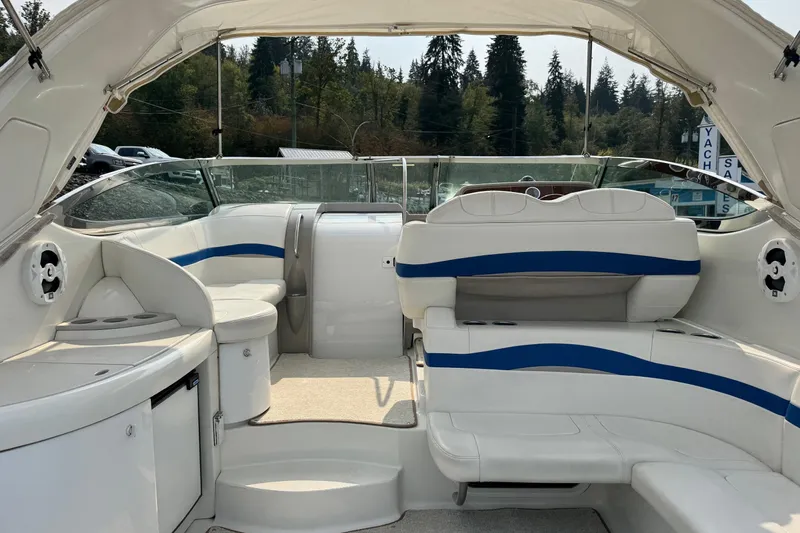  Yacht Photos Pics 2003 Formula 37 Performance Cruiser interior with white and blue seating, surrounded by trees.