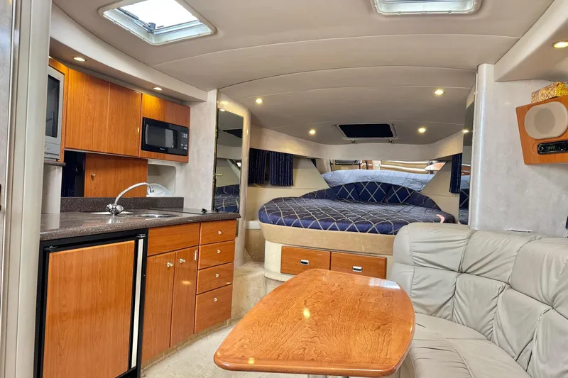  Yacht Photos Pics Luxurious interior of a 2003 Formula 37 Performance Cruiser with kitchen and cozy sleeping area.