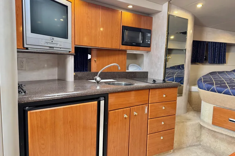  Yacht Photos Pics 2003 Formula 37 Performance Cruiser interior with kitchenette, TV, and bed.