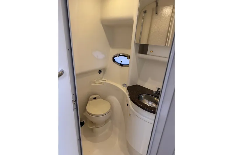  Yacht Photos Pics 2003 Formula 37 Performance Cruiser bathroom with toilet, sink, and porthole window.
