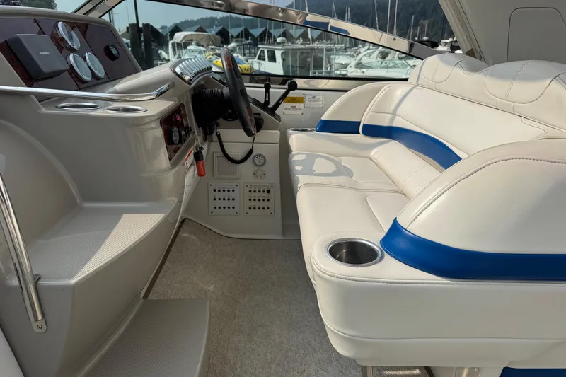  Yacht Photos Pics 2003 Formula 37 Performance Cruiser cockpit with white and blue seating, steering wheel, and controls.