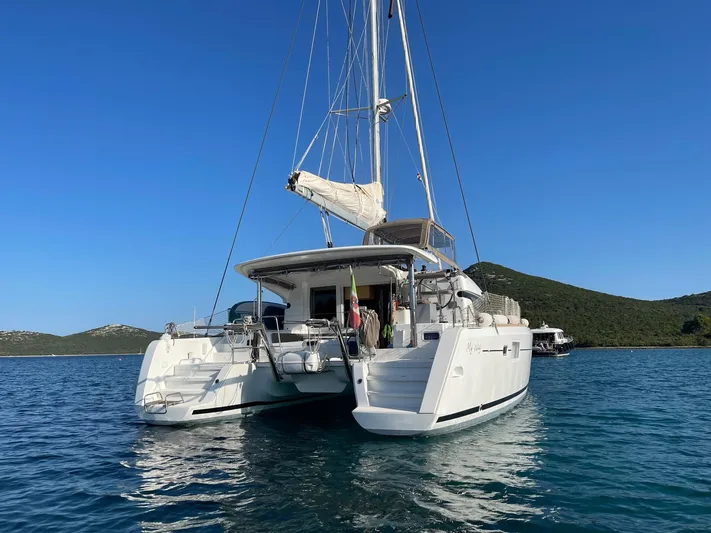 My Way Yacht Photos Pics 2017 Lagoon 39 catamaran anchored in serene blue waters, clear sky backdrop.