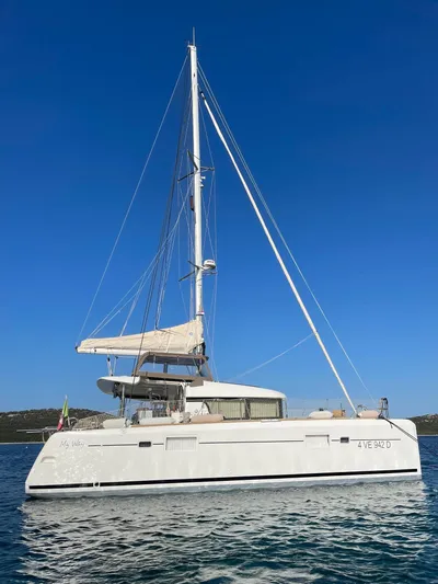My Way Yacht Photos Pics 2017 Lagoon 39 catamaran sailing on calm waters under clear blue sky.