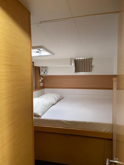 My Way Yacht Photos Pics Cozy cabin interior of 2017 Lagoon 39 catamaran with bed and window.